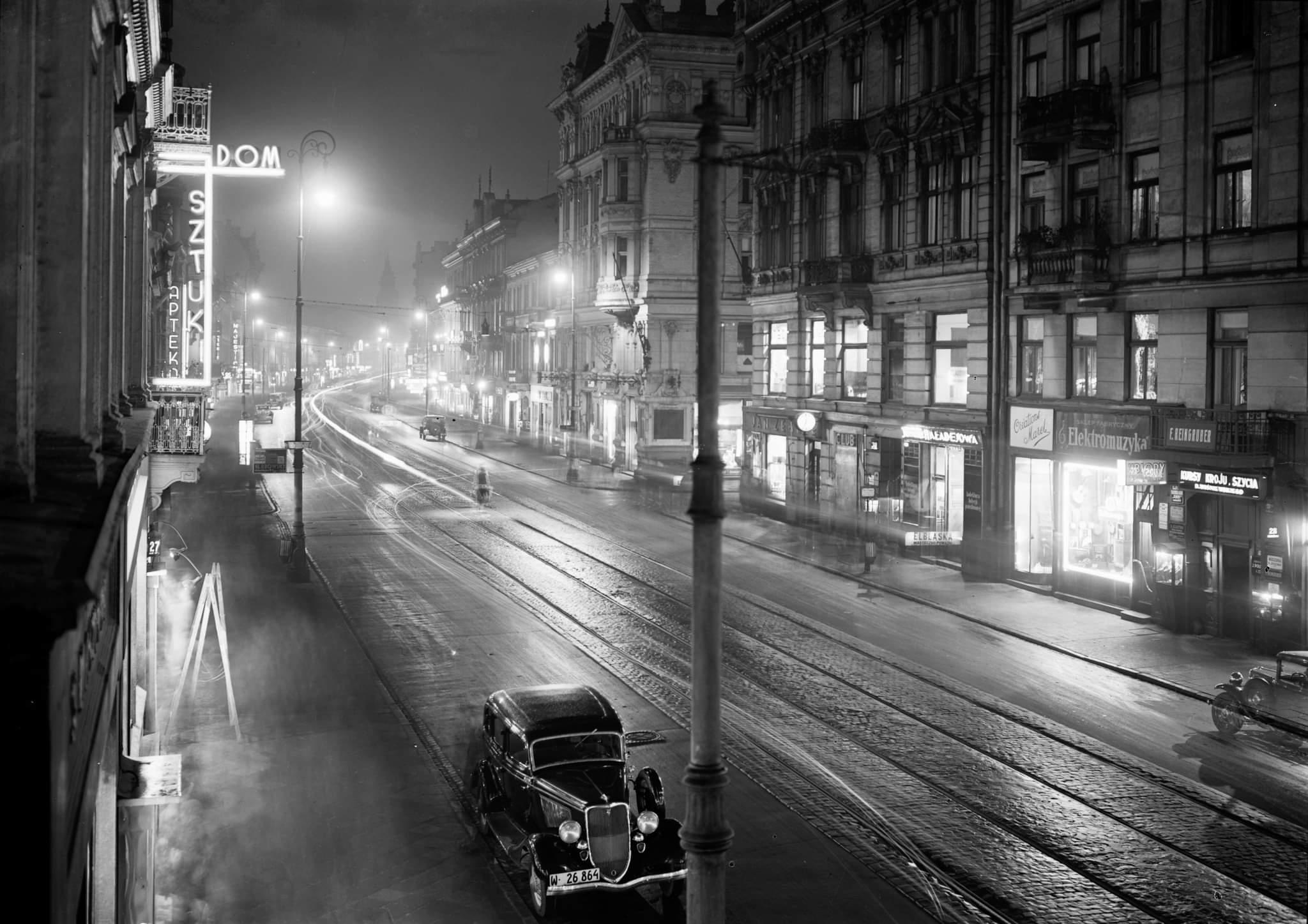 1935. Warsaw at night with a neon glow.